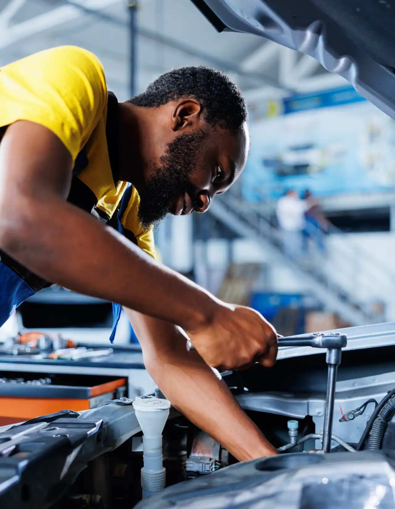 garage-repairman-fixes-broken-car-engine